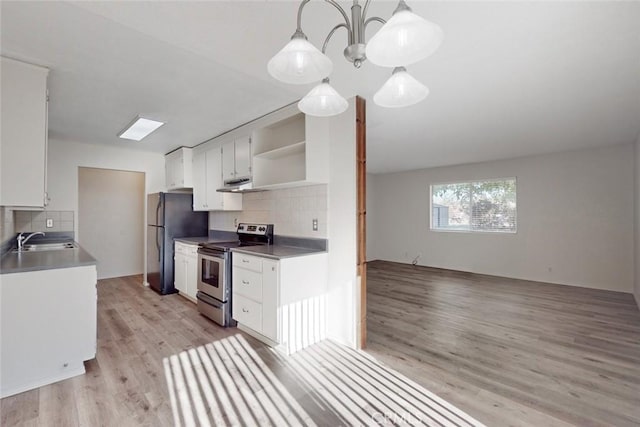 kitchen featuring decorative backsplash, pendant lighting, stainless steel appliances, and sink