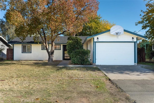 ranch-style house featuring a front yard and a garage