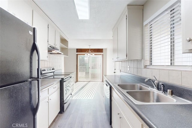 kitchen with white cabinets, appliances with stainless steel finishes, and decorative backsplash