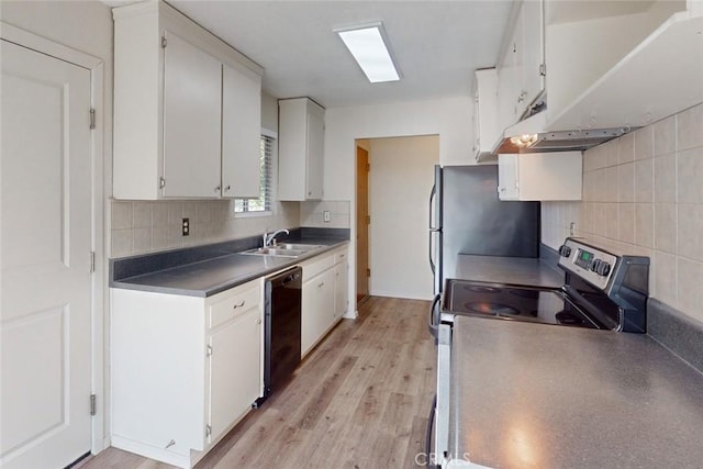 kitchen with decorative backsplash, appliances with stainless steel finishes, sink, light hardwood / wood-style floors, and white cabinetry