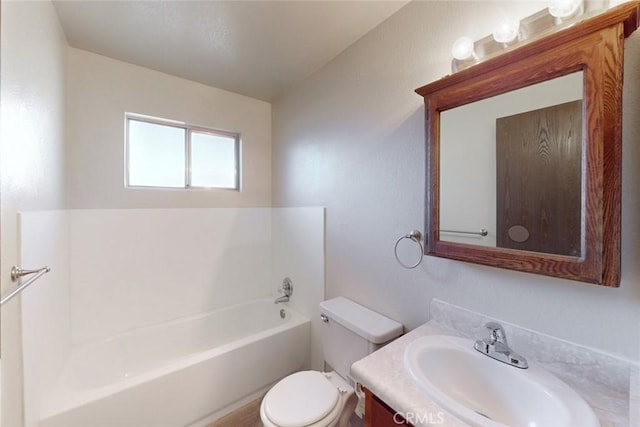 bathroom with vanity, toilet, and a tub