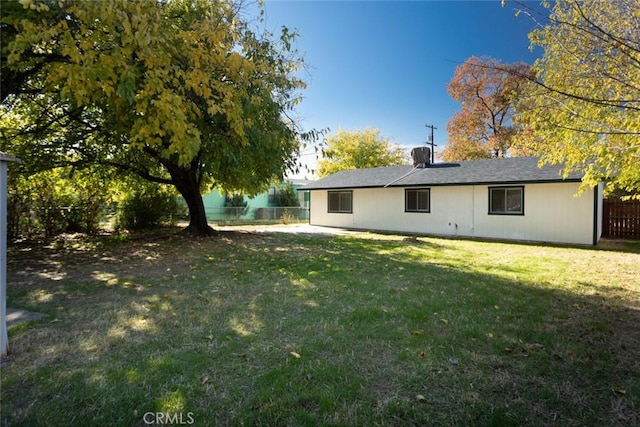 rear view of property with a yard