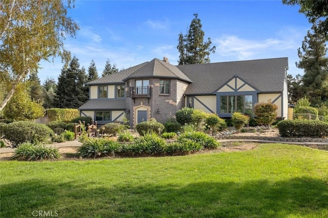 english style home with a front lawn