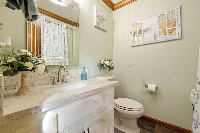 bathroom featuring vanity, toilet, and crown molding