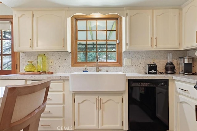 kitchen with dishwasher, decorative backsplash, and sink