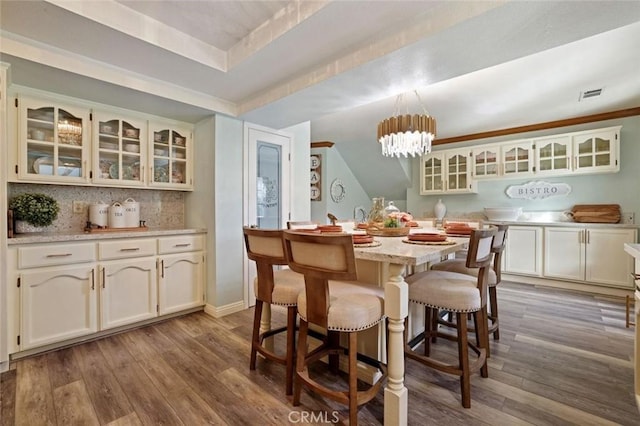 dining space with wood-type flooring