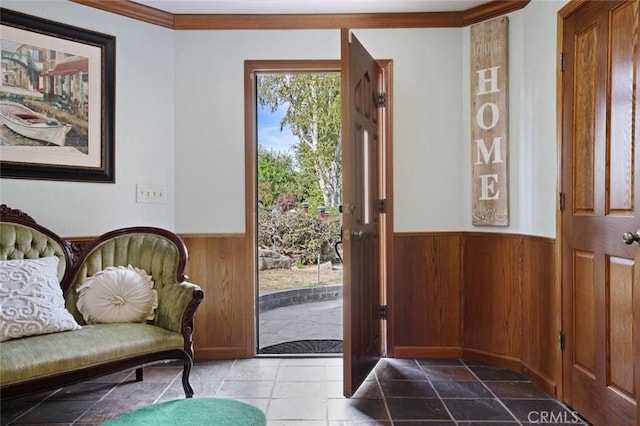 foyer featuring wooden walls and crown molding