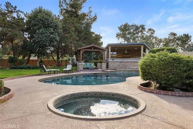 view of pool with ceiling fan, a yard, a gazebo, a patio area, and an in ground hot tub