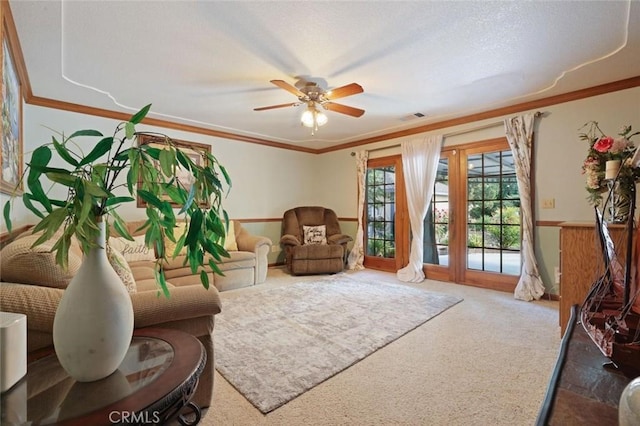 living area with carpet, ceiling fan, and ornamental molding