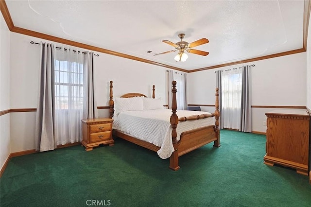 bedroom with multiple windows, ceiling fan, and dark colored carpet