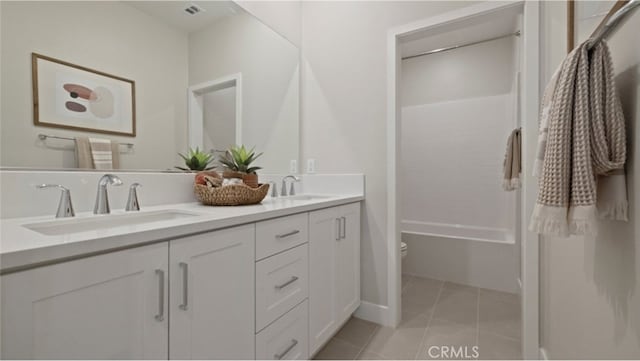 bathroom featuring tile patterned floors, vanity, and toilet