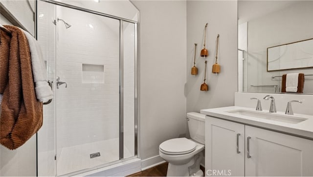 bathroom featuring vanity, toilet, and walk in shower