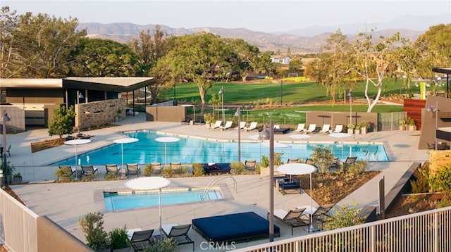 view of pool featuring a mountain view and a patio area