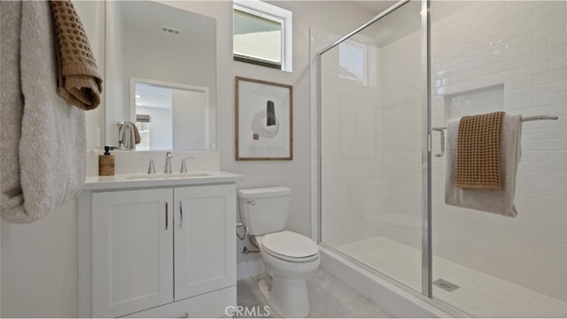 bathroom with vanity, an enclosed shower, and toilet