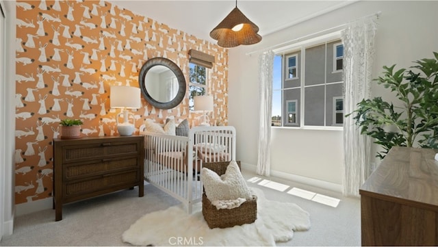 bedroom with light colored carpet and a crib