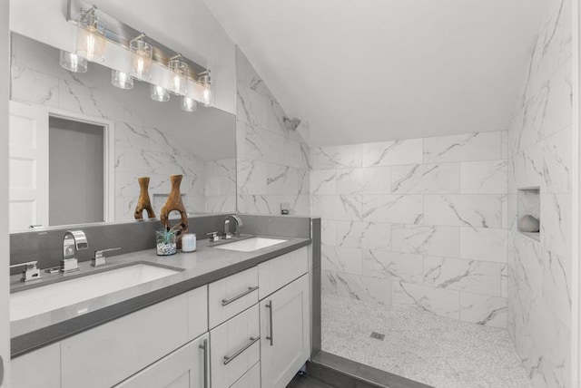 bathroom with vanity, tile walls, and tiled shower