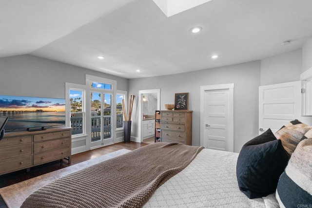 bedroom with hardwood / wood-style flooring, ensuite bath, and lofted ceiling