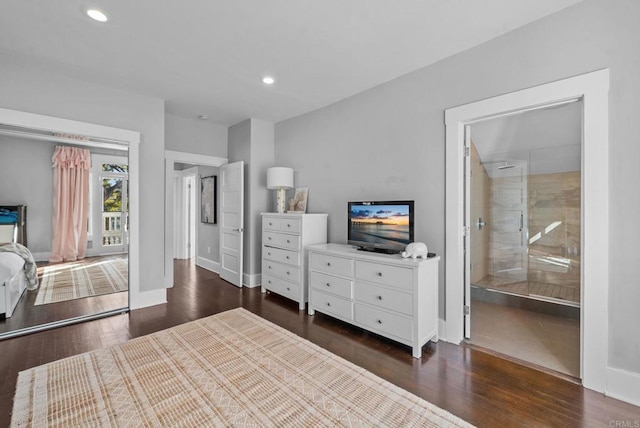 bedroom featuring ensuite bathroom and dark hardwood / wood-style floors