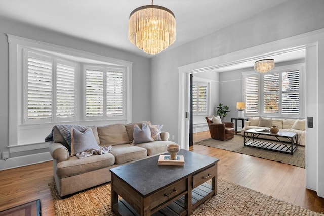 living room with hardwood / wood-style floors and an inviting chandelier