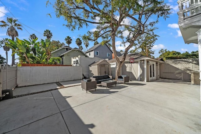 view of patio / terrace with an outdoor living space and a storage shed