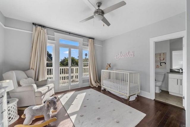 bedroom featuring connected bathroom, ceiling fan, dark hardwood / wood-style flooring, and a nursery area