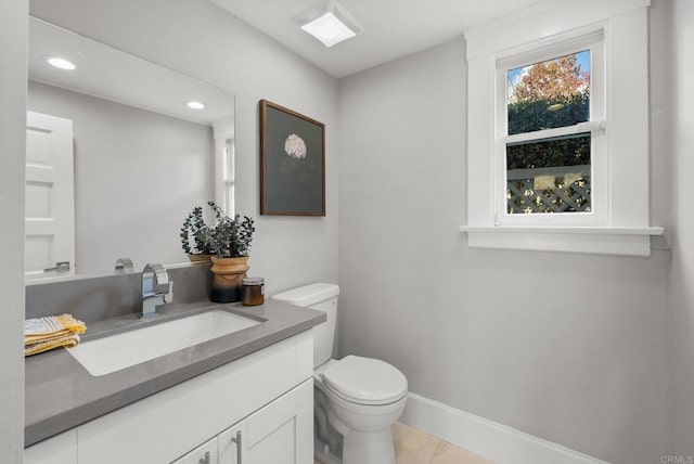 bathroom featuring tile patterned flooring, vanity, and toilet