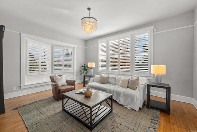 living room with wood-type flooring and a notable chandelier