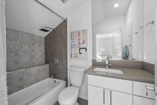 full bathroom with toilet, vanity, lofted ceiling, and tiled shower / bath