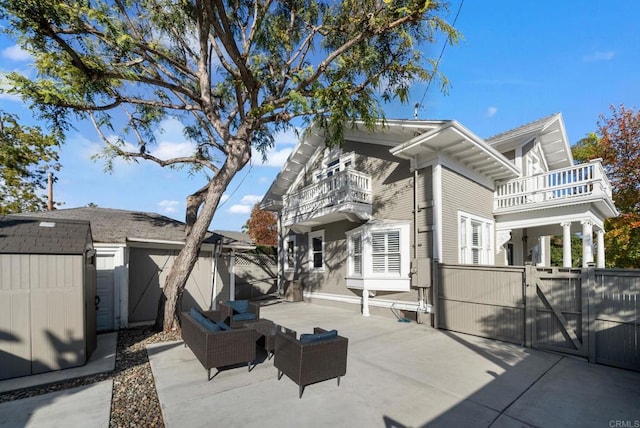 exterior space with a patio area, an outdoor living space, a balcony, and a storage unit