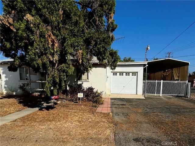 view of front facade with a garage and a carport