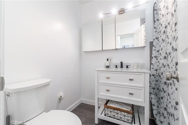 bathroom featuring hardwood / wood-style flooring, vanity, and toilet