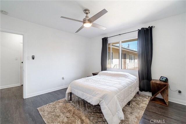 bedroom featuring ceiling fan and dark wood-type flooring