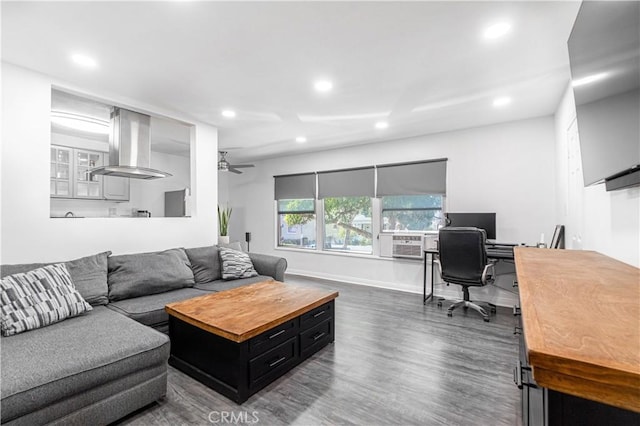 living room featuring ceiling fan and dark hardwood / wood-style flooring