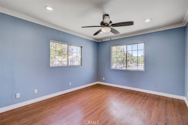 unfurnished room with hardwood / wood-style flooring, ceiling fan, a healthy amount of sunlight, and ornamental molding