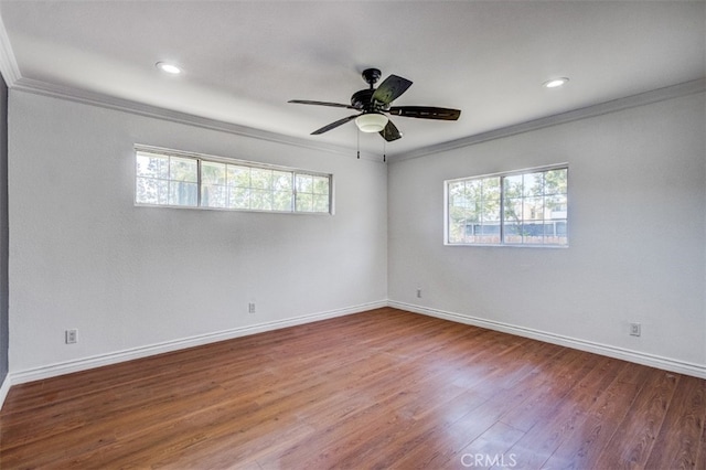 empty room with ceiling fan, hardwood / wood-style floors, and ornamental molding