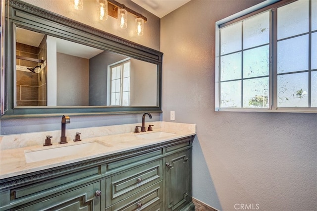 bathroom featuring plenty of natural light and vanity