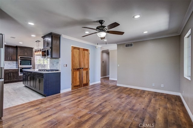 kitchen featuring light hardwood / wood-style floors, dark brown cabinetry, stainless steel appliances, and ornamental molding