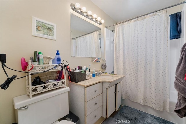 full bathroom featuring vanity, shower / bath combination with curtain, and toilet