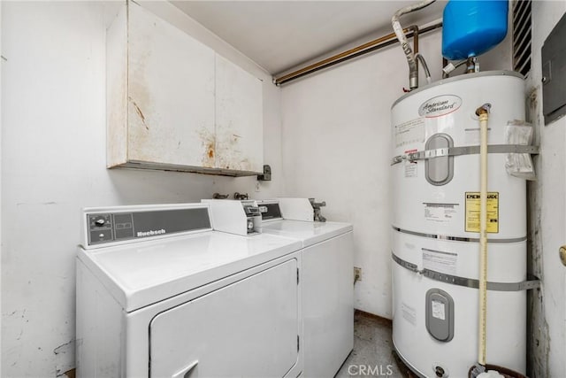 clothes washing area featuring water heater and washer and dryer