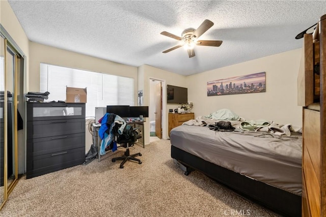 bedroom featuring a closet, ceiling fan, a textured ceiling, and carpet