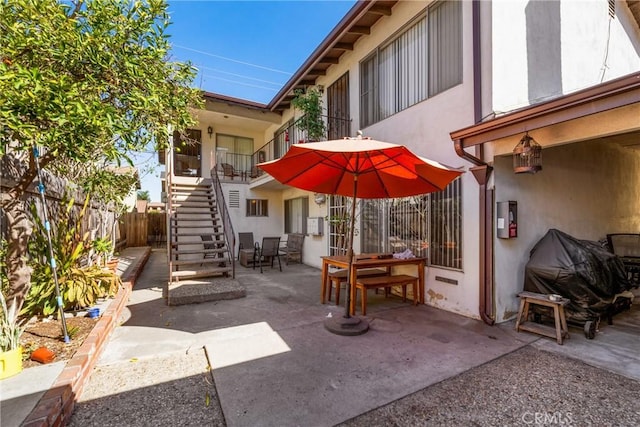 view of patio / terrace featuring stairs and fence