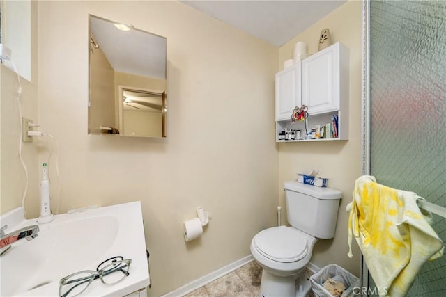 bathroom featuring sink, tile patterned floors, and toilet