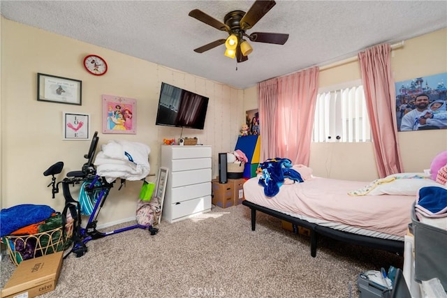 bedroom featuring ceiling fan, carpet, and a textured ceiling