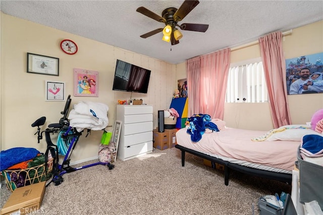 bedroom with carpet floors, a textured ceiling, and ceiling fan