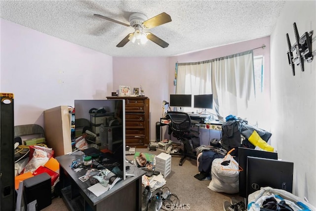 office area featuring ceiling fan, carpet flooring, and a textured ceiling