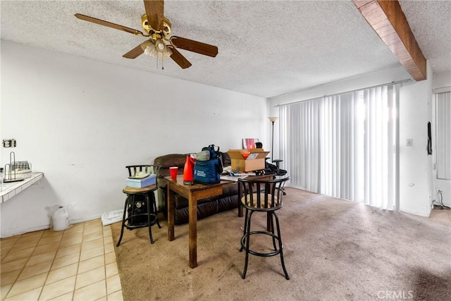 tiled dining area with ceiling fan and a textured ceiling