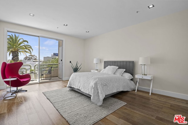 bedroom featuring access to exterior and wood-type flooring