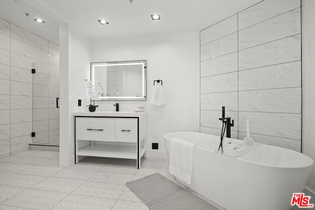 bathroom with tile patterned floors, vanity, and plus walk in shower