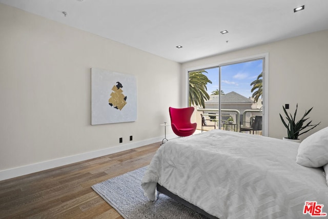 bedroom featuring access to outside and hardwood / wood-style flooring