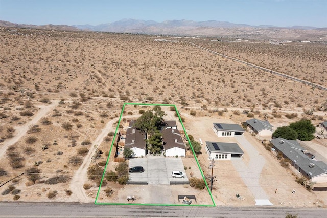 birds eye view of property with a mountain view